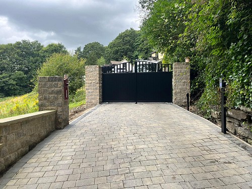 Black Aluminium Cladded Steel Electric Gates from a distance